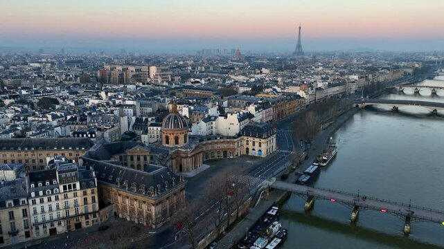 drone shot of Paris at sunrise with Seine river and Cite island, morning aerial view of Paris, capital of France, French tourism