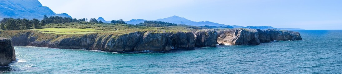 Fototapeta premium Cliffs at Bufones of Pria in the Cantabrian Sea also known as the Pria Blowholes, are a fascinating natural geological phenomenon located on the northern coast of Asturias, Spain.