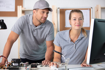 young female and male workers in a factory