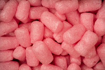 Pink and white box filler as a background. Top view.