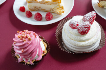desserts with raspberries on white plates on the table