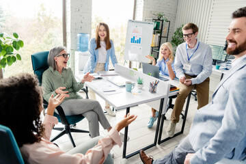 Obraz premium Team of diverse professionals collaborating at modern office workspace