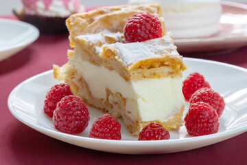 desserts with raspberries on white plates on the table