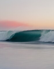 A single ocean wave crashing against a white, isolated sand beach under a serene sunset sky.