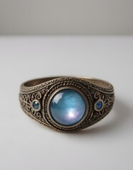 A detailed description for a vintage ring featuring a large, round gemstone with intricate detailing.