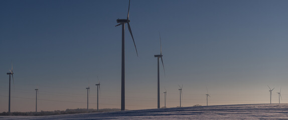  WIND FARM - Turbines in snowy fields against a blue sky

