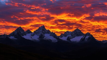 Fiery sunrise over snow-capped mountain peaks