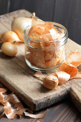 Onion peel is natural color for easter in a glass jar on wooden rustic background, closeup, heart...