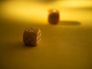 Yellow dice on yellow background