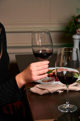 people are cheering with two glasses of red wine