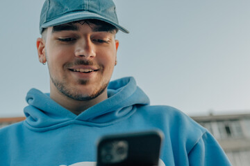 close-up low angle shot of young man with mobile phone or smartphone