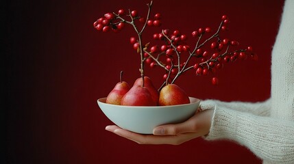   A person cradling a bowl brimming with ruby-red berries atop a protruding twig