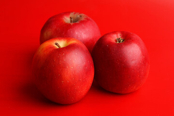set of red apples on red background