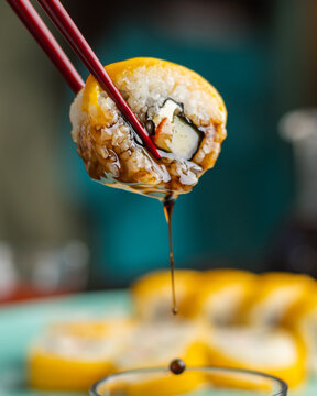 Sushi oll dipped in sauce
