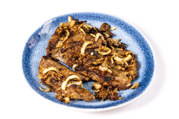 A blue plate of fried pork or beef liver and onions isolated on white