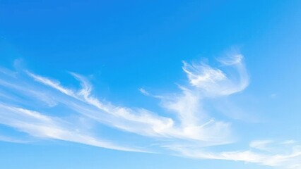 cloudless blue sky with a few wispy white clouds at dawn, soft, blue