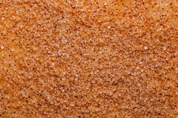 Sanding Sugar with cinnamon powder close-up. Granulated sugar on raw dough - macro photo. Natural food background