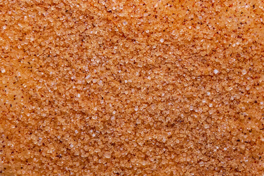 Sanding Sugar with cinnamon powder close-up. Granulated sugar on raw dough - macro photo. Natural food background