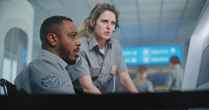 Airport Security Checkpoint: Two Diverse TSA Workers Monitoring X-ray Scanning of Suitcase on Computer Monitors Using Modern Program. Advanced Baggage Screening Procedure Technology, Metal Detector.