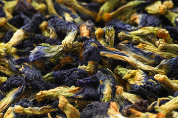 Butterfly pea flower tea. Dry Clitoria ternatea petals as background, closeup