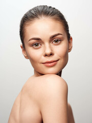 Portrait of beautiful young woman with flawless skin and confident gaze, isolated on white...