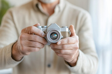 Senior photographer adjusting focus on a vintage camera, showcasing expertise and passion for traditional photography while capturing nostalgic moments with precision