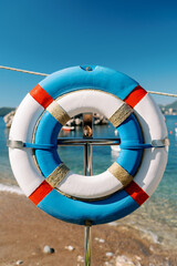 Large and small lifebuoy hanging on a rack on the seashore