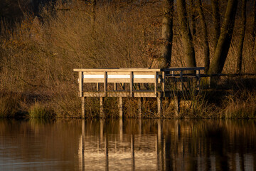 Wooden Observation Deck by the Lake. A serene wooden observation deck standing by a calm lake,...