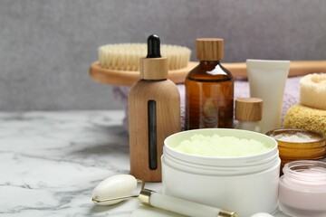 Different body care products on white marble table, closeup. Space for text
