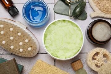 Different body care products on light tiled table, flat lay