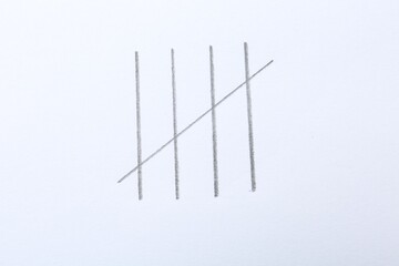 Counting days by drawing sticks with pencil on white background, closeup