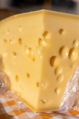Piece of delicious emental cheese with holes