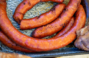 Traditional german street food - fried sausages in big frying pan