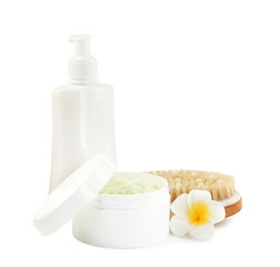 Different body care products and plumeria flower isolated on white