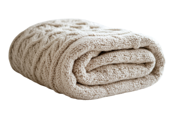 Cozy beige knitted blanket folded neatly on a white surface for home decor or winter warmth