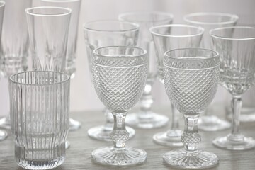 Empty clean glasses on wooden table indoors, closeup