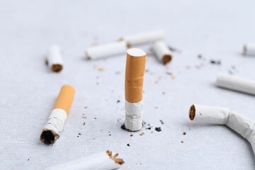 Many cigarette butts on light background. Smoking habit