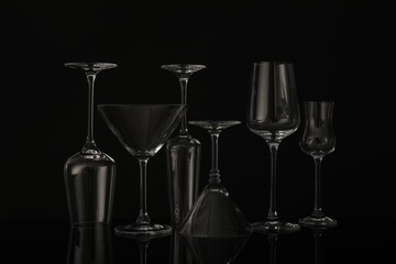 Many empty clean glasses on black background