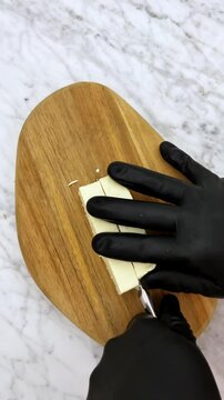 Cutting fresh Mexican cheese into pieces