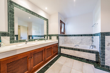 an image of a large mediterranean bathroom with bathtub and ceramic wall tiles 