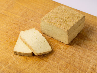 Tofu Cheese Isolated, Smoked Vegan Cheese Slice, Sliced Soya Bean Curd, Soy Protein or TSP