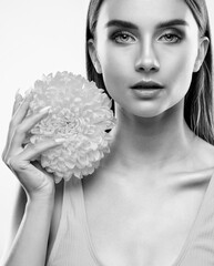 Portrait of an attractive girl with healthy clean skin and beautiful makeup, she is holding a...
