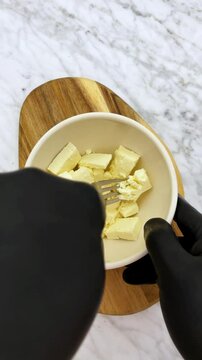 smashing fresh cheese in to curds for recipes