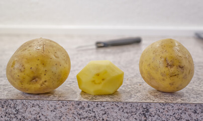 Three Potatoes on a Kitchen Countertop