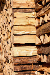 Prepared stacks of firewood, used to heat a house, lie neatly in rows at a logging yard (from the series 