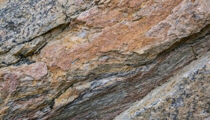 Layered sedimentary rock texture, background featuring warm orange and gray striations. The wavy layers indicate ancient geological processes, creating a natural pattern of compacted minerals