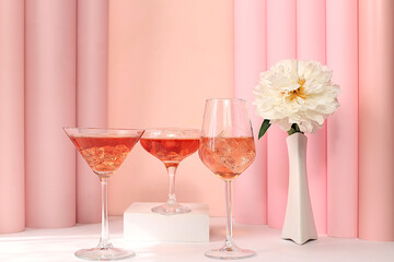 Festive alcoholic cocktail Aperol spritz, red Martini, tequila in glasses on a bright background with a bouquet of peonies, summer bar concept, alcoholic drinks at a party,