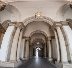 grand archway corridor with stone columns.