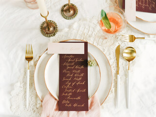 Elegant table setting with personalized menu and refreshing drink for a special occasion dinner