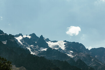 Glacier melting on mountain peaks under blue sky